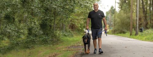 Greg Edgelow walks his dog along the Burnaby multi-use pathway